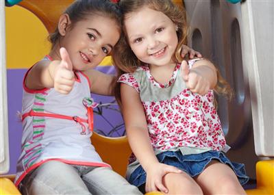  young students giving thumbs up